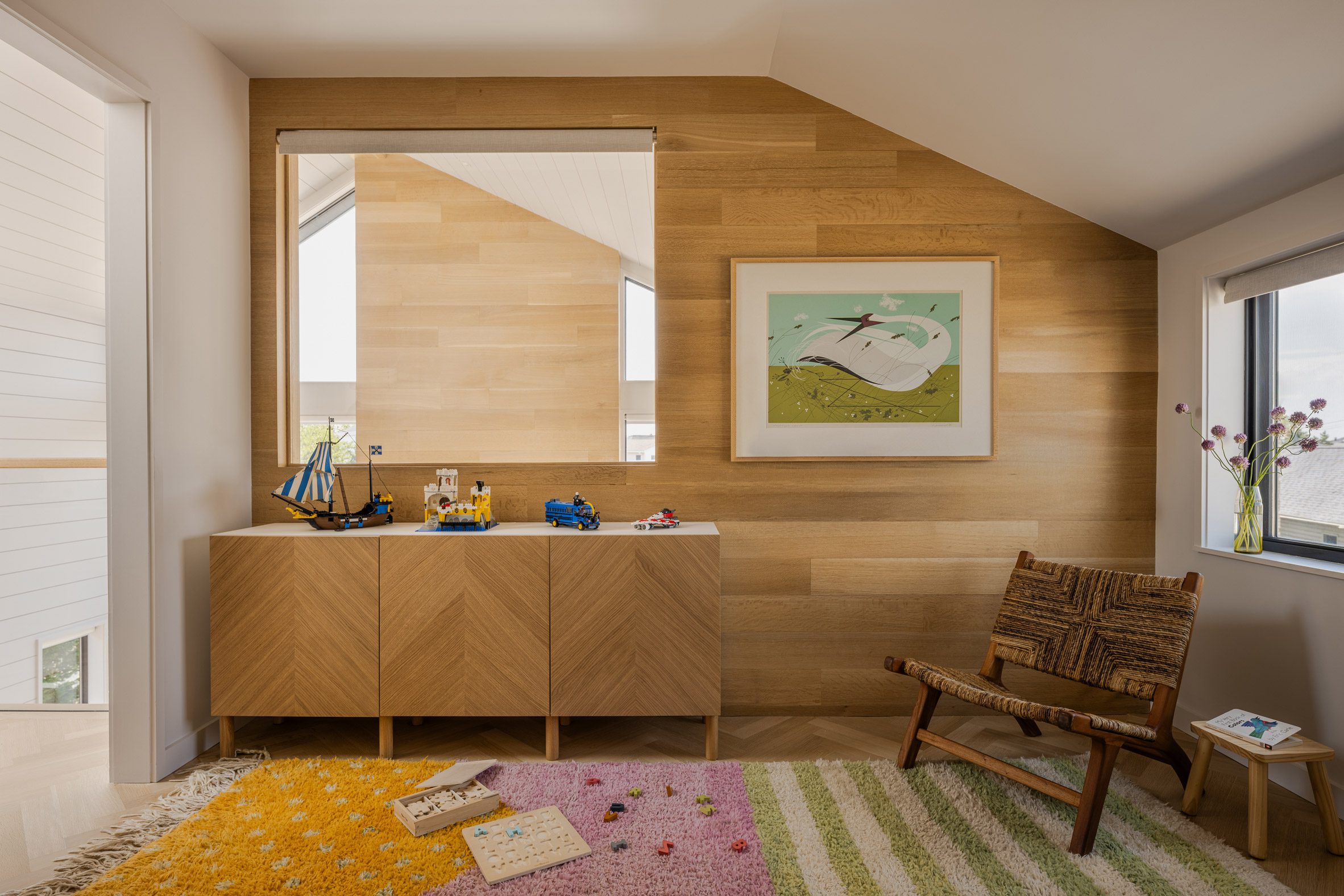 Slanted roof section expressed in an upstairs playrooms, which overlooks a living area below