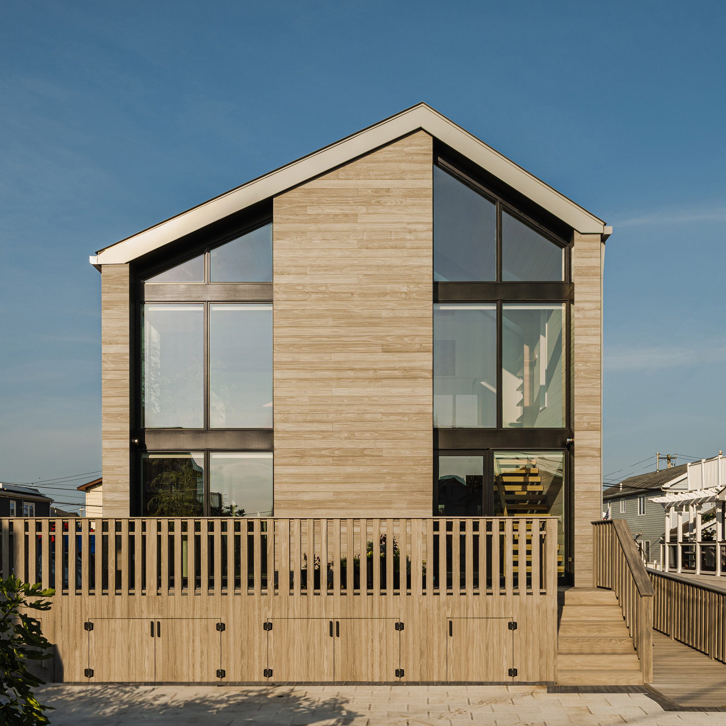 A house in Breezy Point featurinf an offset gabled roof and weather-resistant accoya siding