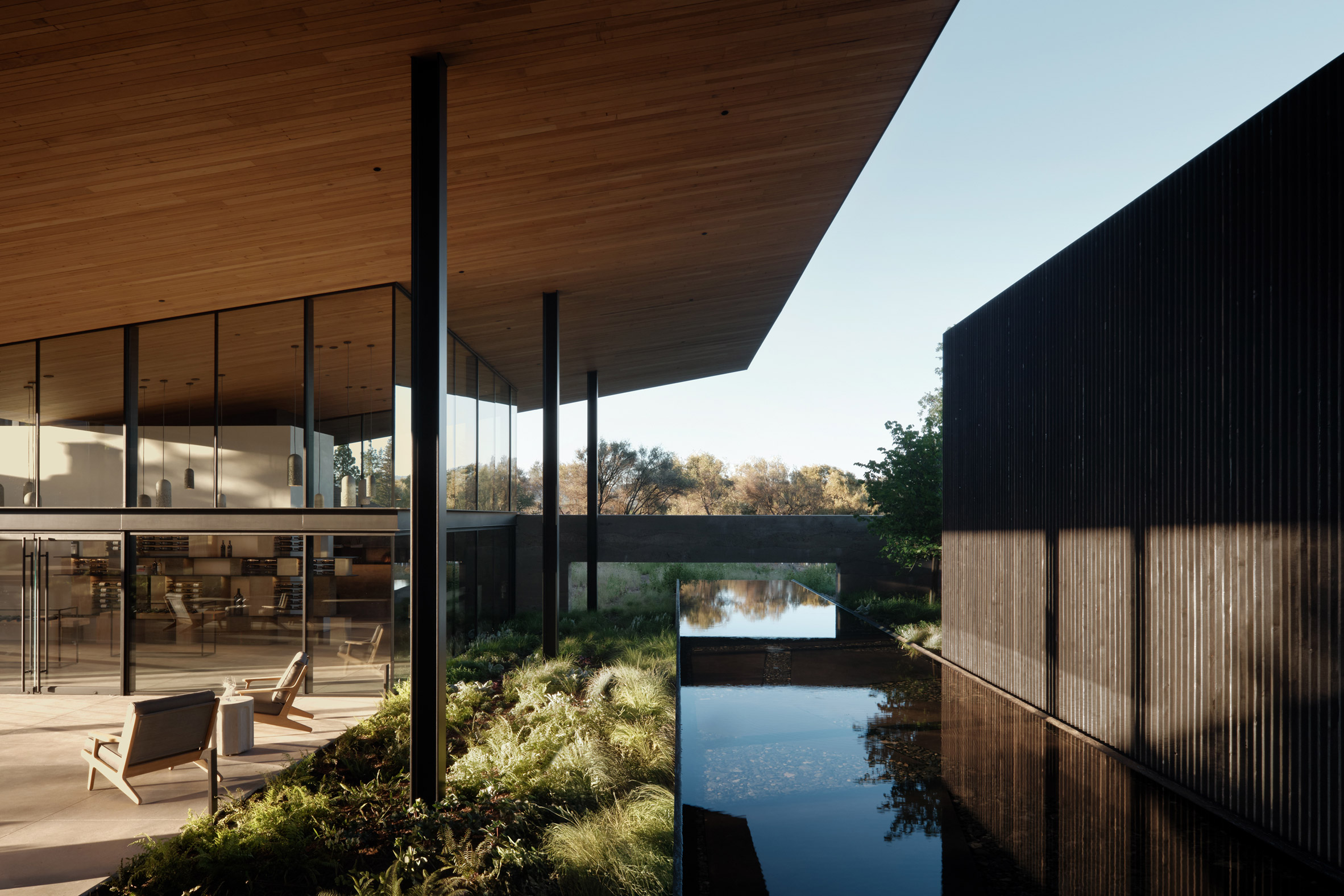 Building with broad roof and reflecting pool