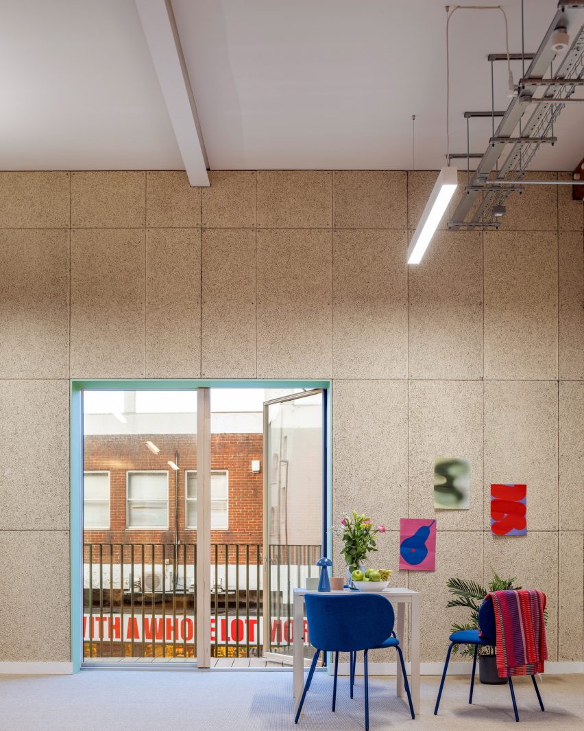 Community space lined with wood-wool wall panels
