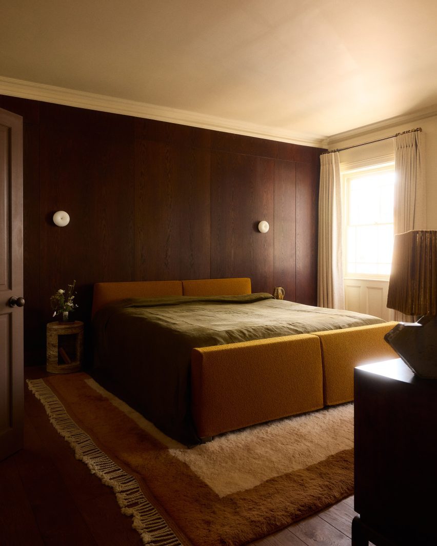 Bedroom with dark timber panelling