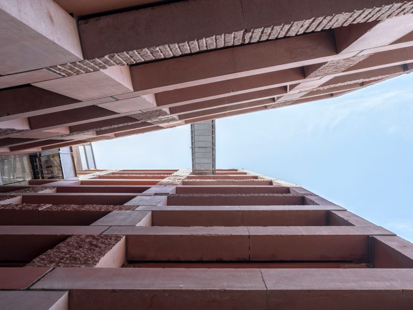 Steel walkway going over two stone towers