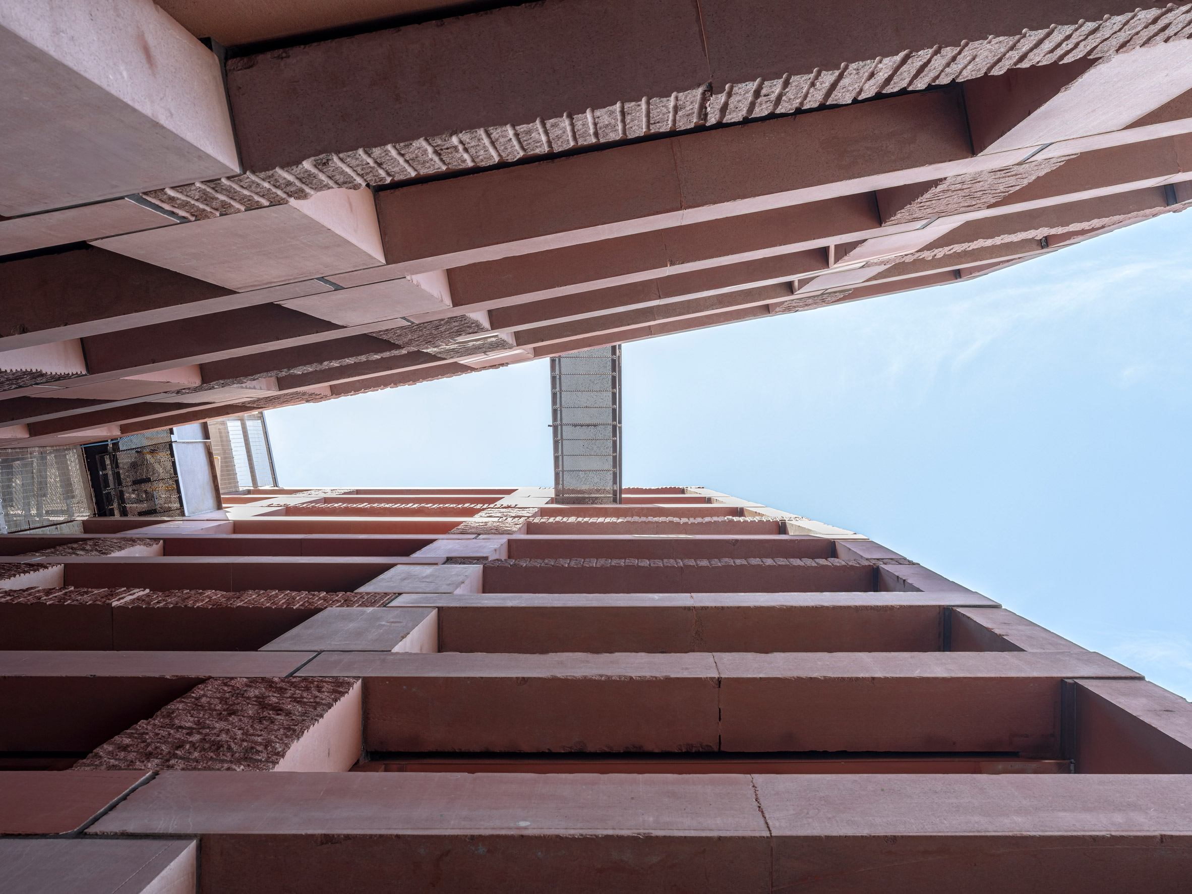 Steel walkway going over two stone towers