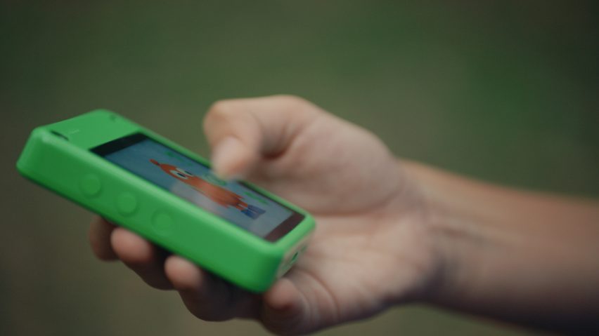 Close-up photo of the Freckle phone screen showing an animated characer