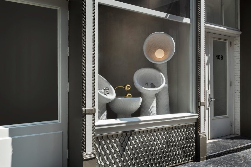 A window installation featuring hand-sculpted vessels faces SoHo's Wooster Street