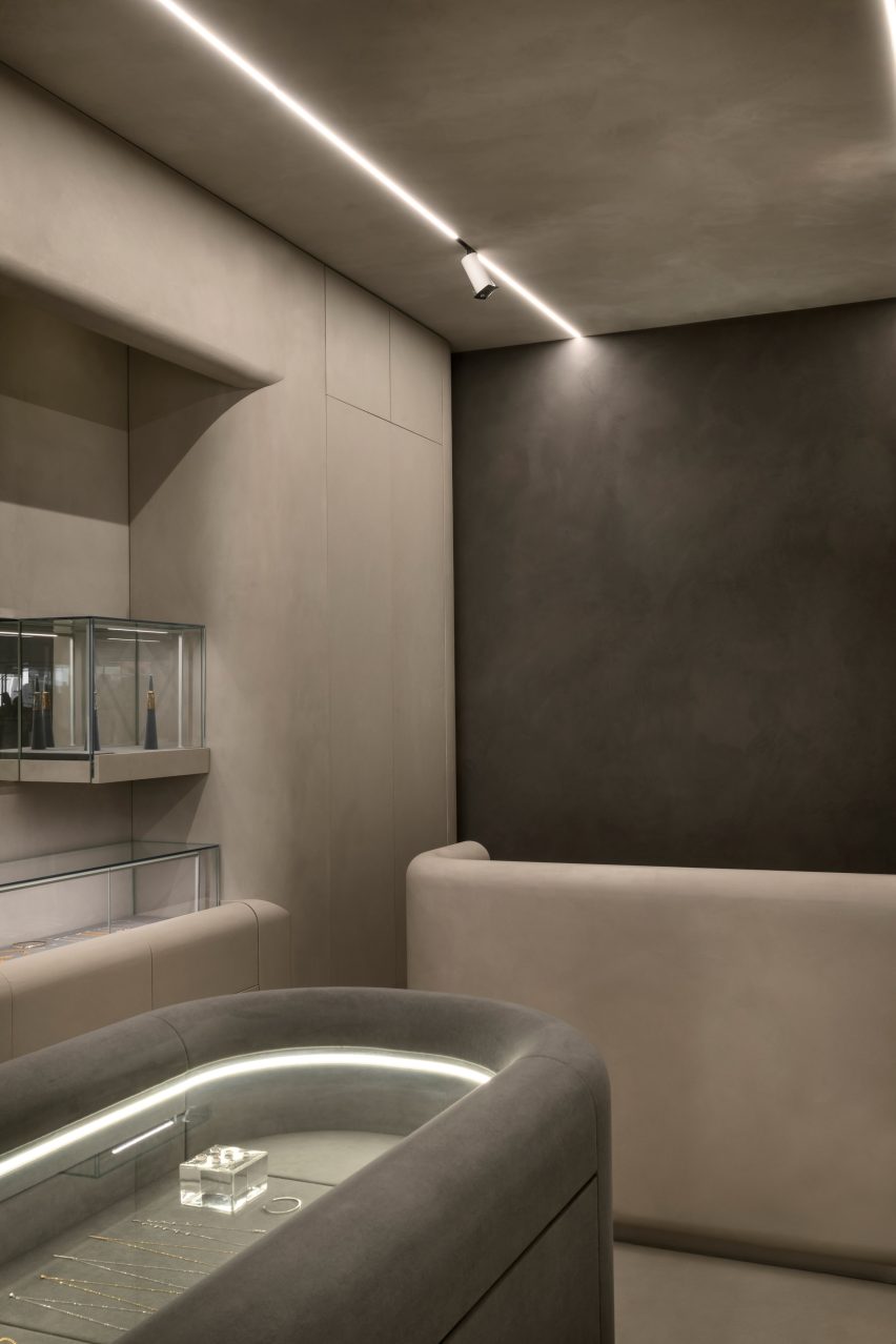 Mineral-toned plaster creates texture across portions of a store's walls and ceiling