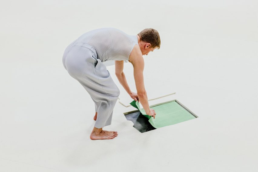 Man pulling clothes from floor