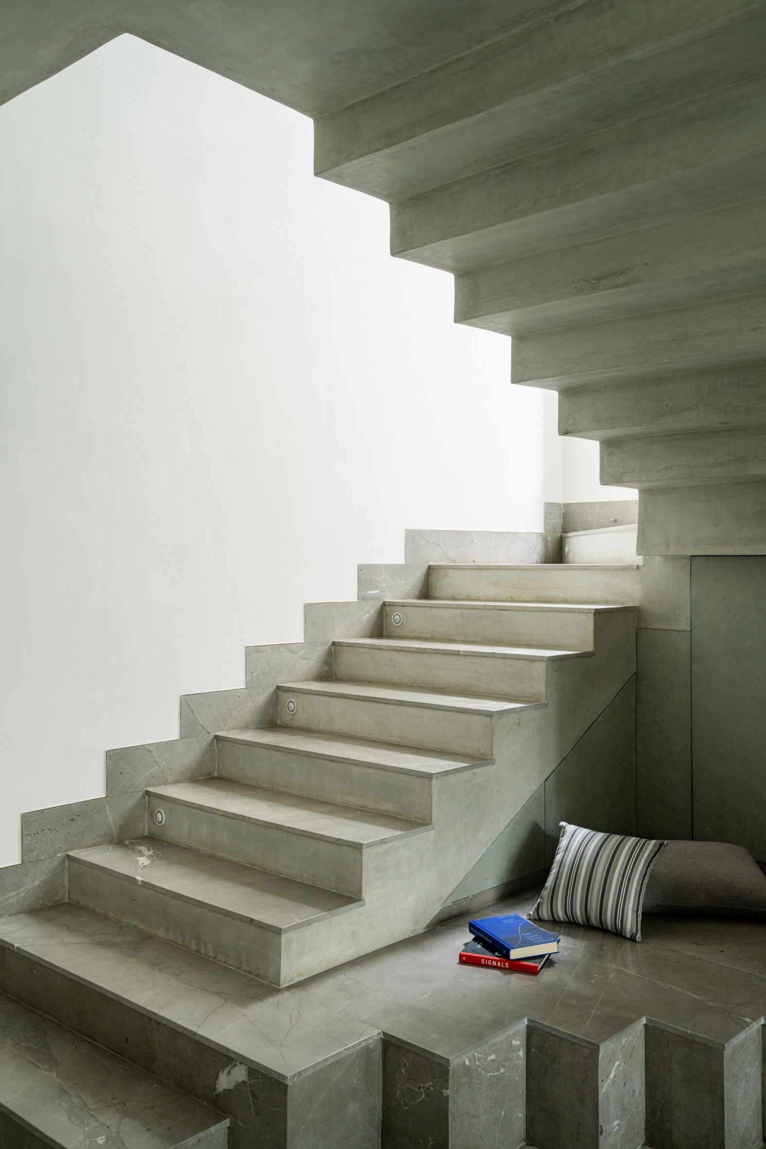 Concrete staircase with reading nook