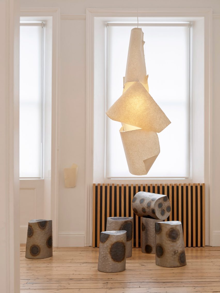 Metal stools beneath a paper lampshade