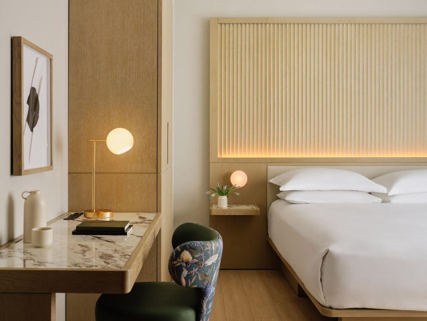 White oak millwork integrates multiple furniture pieces in a hotel room