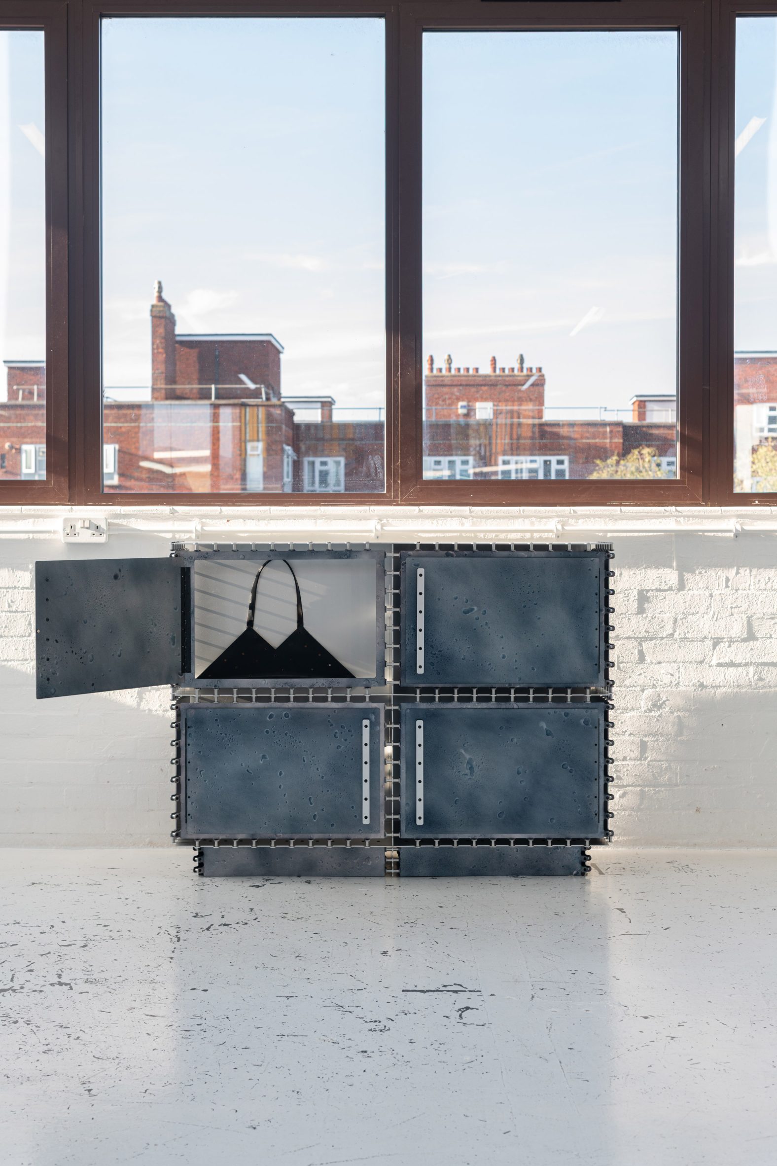 Metal sideboard with bag in it