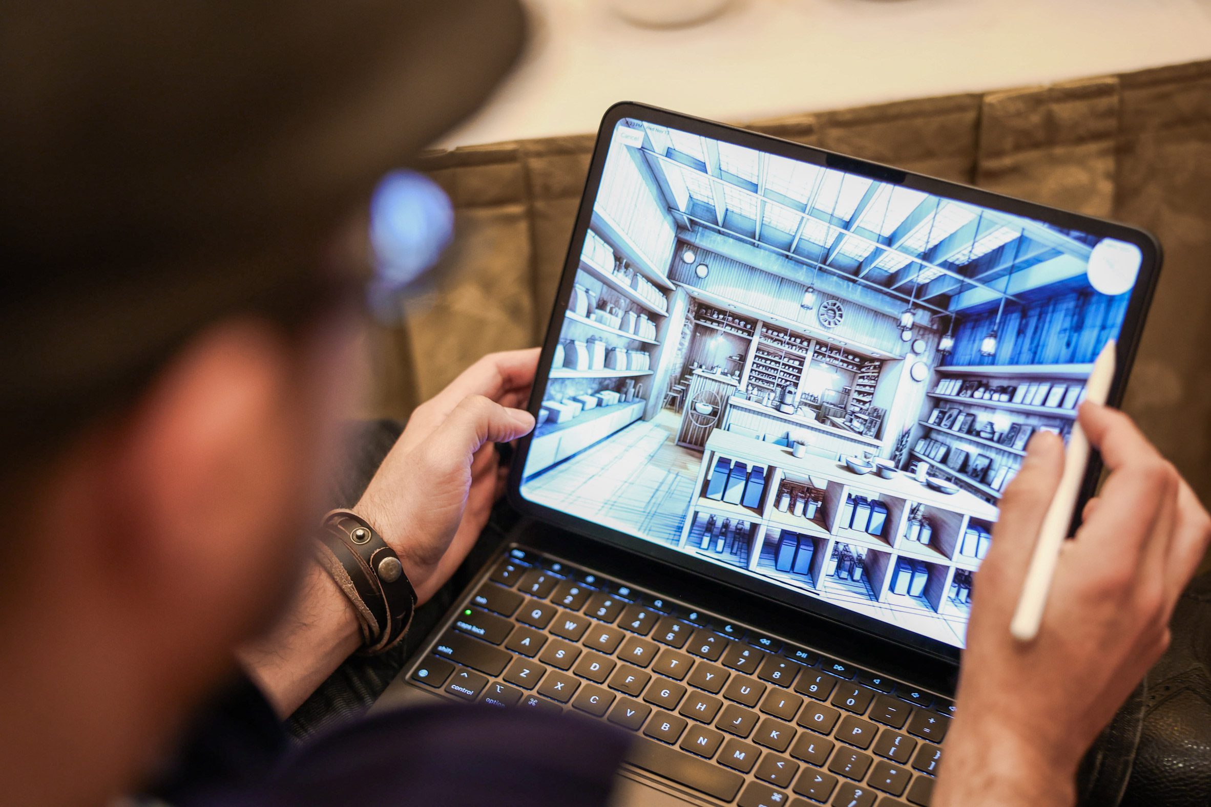 An attendee uses a stylus to navigate a detailed 3D interior model displayed on a tablet