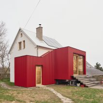 "Deliberately distinct" red extension added to former-pigsty home