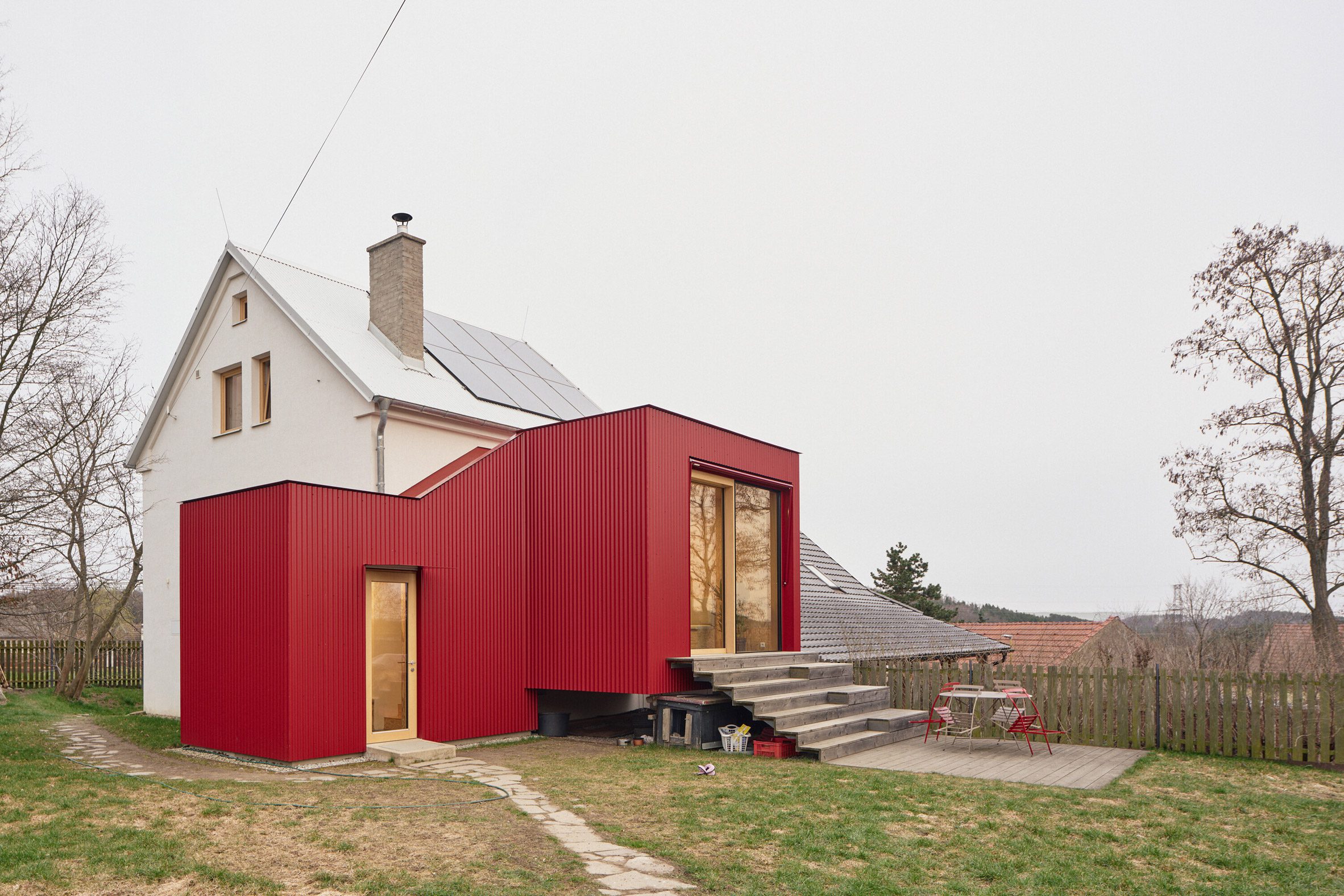 the extension adds seating steps and a terrace to improve outdoor access