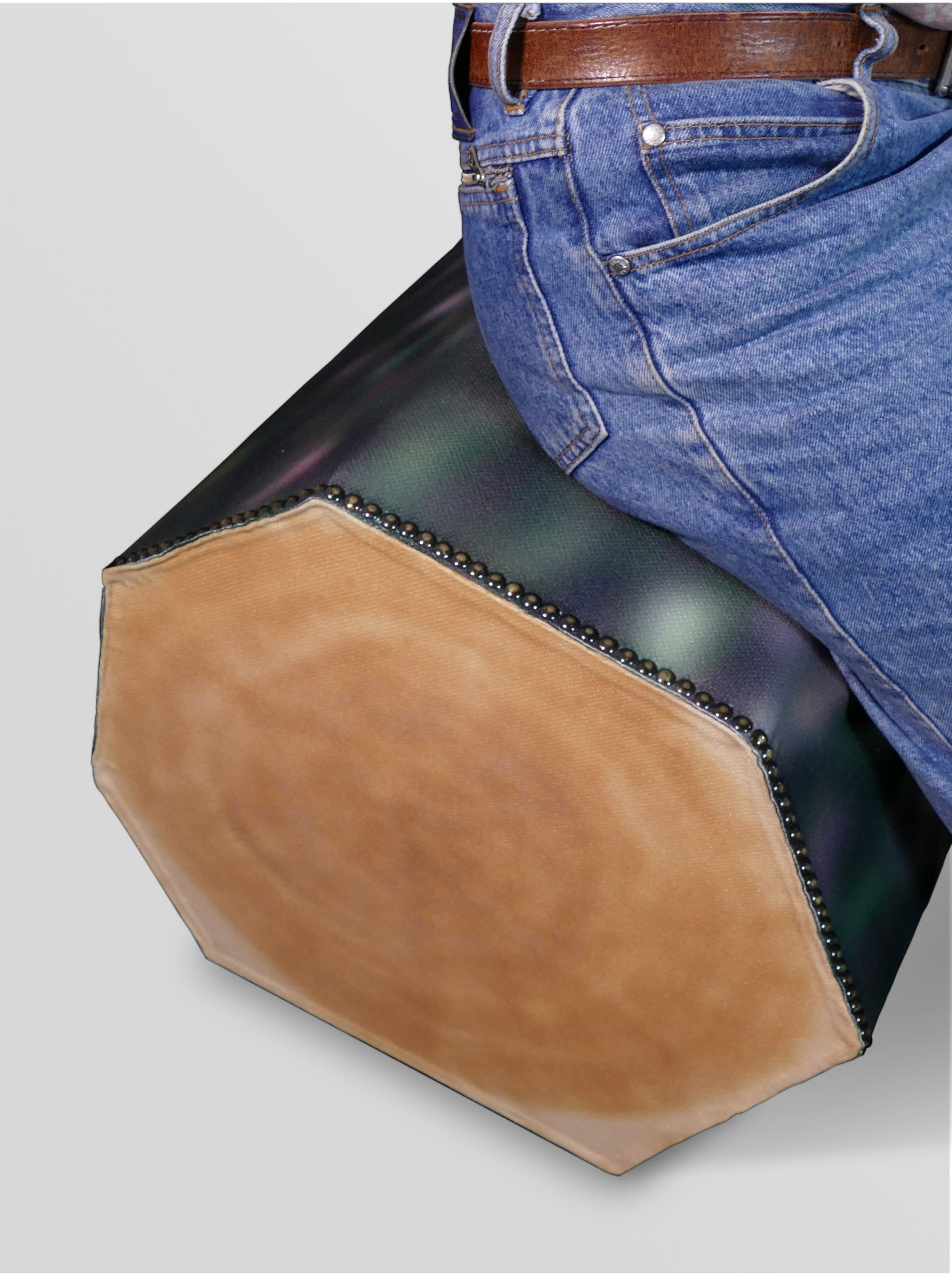 Person wearing jeans sitting on log-like bench